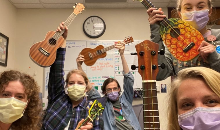 5 music therapists proudly holding their UKC ukuleles as an expression of gratitude
