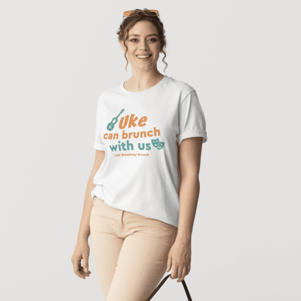A woman modeling the official tee of the UKC 2026 Broadway Brunch.