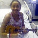 Smiling pediatric patient receiving a UKC ukulele